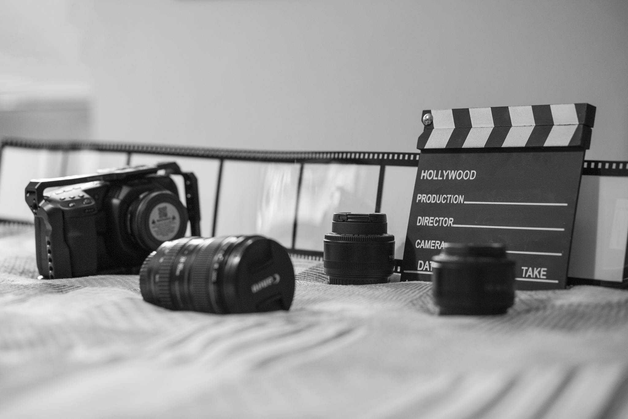 Black and white photo of vintage film equipment with camera and clapperboard.