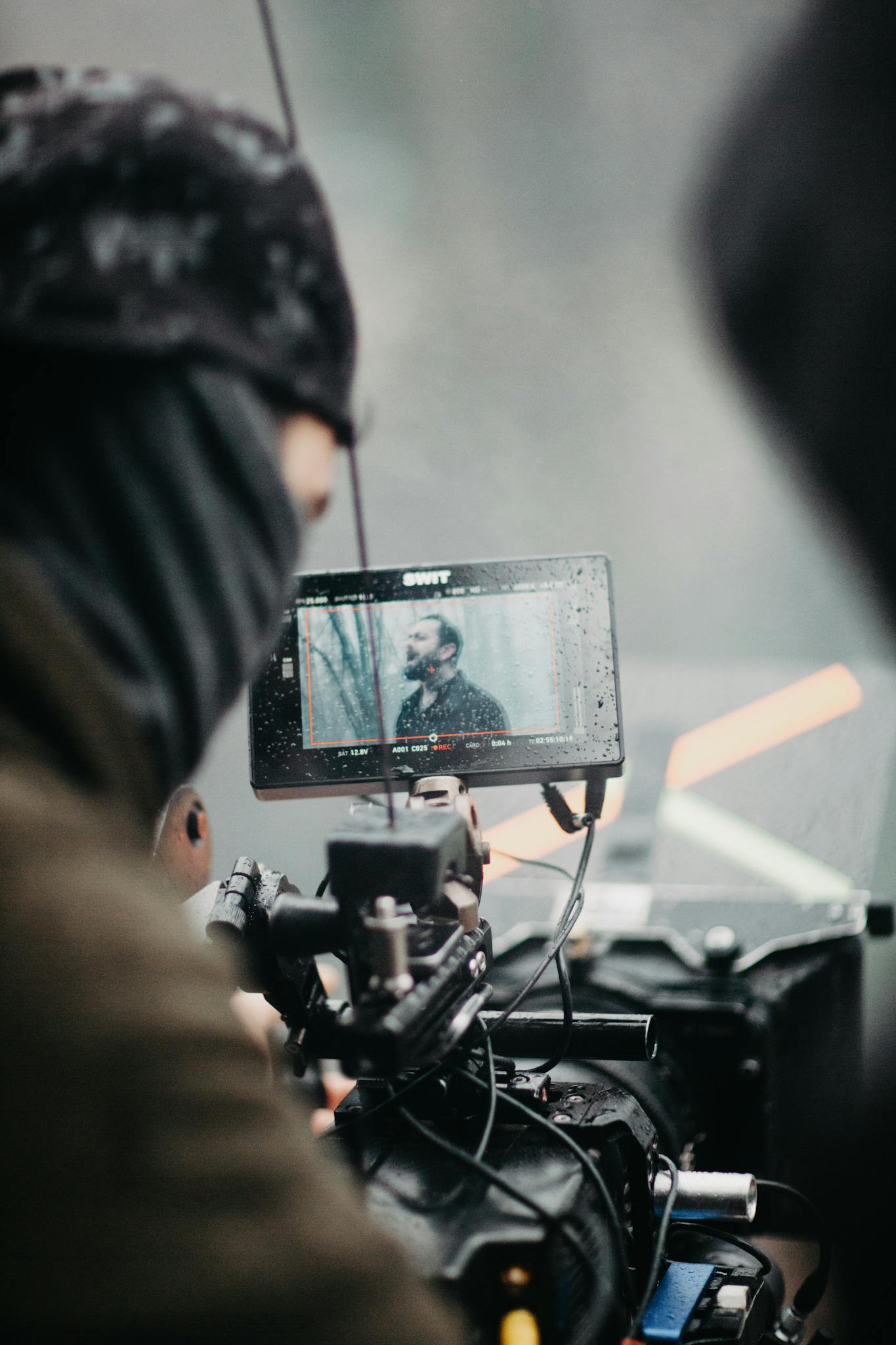 Film crew capturing footage on set with a professional camera and monitor.