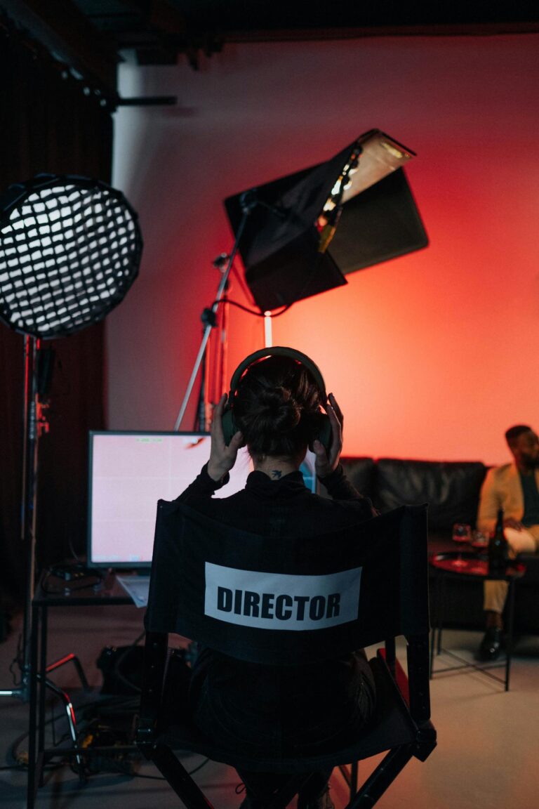 Film director in chair with headphones in a studio setting.